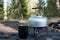 Aluminum kettle on gas camping stove. Camping kitchen. Picnic. Cooking at nature. Making tea. Boil water. Aluminum teapot on gas s