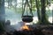 aluminum kettle hanging over a campfire with rooibos tea