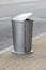 Aluminum trash can on walkway