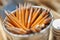 Aluminum vase with yellow graphite pencils. close-up, blurred background. close-up