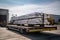 alumum ingot being transported by truck to manufacturing facility