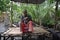 Aluthgama, Sri Lanka - May 04, 2018: Man on a wooden pier holds in hands a small crocodile