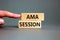 AMA ask me anything session symbol. Concept words AMA ask me anything session on wooden blocks on a beautiful grey background.