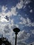 Amaizing view of beautiful sun shining skies, road lamp silhouette. Skies view and clouds concept