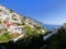 Amalfi Coast views of the ocean and homes built into the mountain cliffs in Positano, Italy