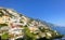 Amalfi Coast views of the ocean and homes built into the mountain cliffs in Positano, Italy