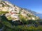 Amalfi Coast views of the ocean and homes built into the mountain cliffs in Positano, Italy