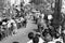 AMALFI, ITALY, 1960 - The torch bearer marches through the streets of Amalfi between two crowd wings with his torch to Rome for