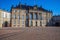 Amalienborg palace on empty street and historical building with statues and columns