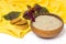 Amaranth plant and flour in ceramic bowl, amaranth cookies on yellow cloth