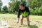 Amateur Asian man tests and tries to transplant rice seedlings in paddy rice field in the open sky day