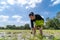 Amateur Asian man tests and tries to transplant rice seedlings in paddy rice field in the open sky day