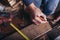 Amateur carpenter measures the board