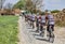 Amateur Cyclists on a Cobblestone Road