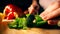 Amateur female cook cutting green sweet pepper