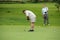 Amateur golfers playing a round of golf as a recreational pursuit