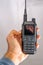amateur radio walkie talkie portable triband held in the hand of a white ma