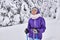 Amateur skier girl in winter snowy forest