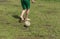 amateur soccer player doing trick with heel and shabby ball on bad lawn
