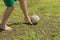 Amateur soccer player on old and bad field with shabby ball