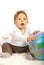 Amazed baby with world globe