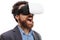 Amazed bearded man wearing virtual reality goggles