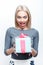 Amazed blond-haired woman getting present