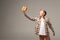 Amazed boy holding gift box in outstretched hand