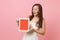 Amazed bride woman in wedding dress holding looking on tablet pc computer with blank black empty screen on