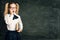 Amazed Child Girl on School Blackboard Background, Astonished Kid over Black Chalk Board