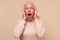 Amazed elderly woman looking surprised and shocked