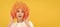 amazed fancy party look. freaky woman in clown wig on yellow background. express positive emotions. Woman isolated face