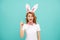 amazed inspired with idea easter woman with bunny ears on blue background