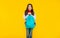 amazed kid has long curly hair carry school backpack on yellow background, college