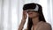 Amazed lady playing video game in virtual reality, spinning head in VR, emotions