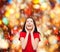 Amazed laughing young woman in red dress