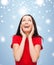 Amazed laughing young woman in red dress