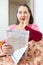 Amazed mature woman with newspaper