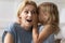 Amazed mother hears incredible news from little daughter closeup image