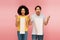 amazed multiethnic couple holding shopping bags