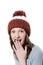 Amazed pretty young girl in winter knitted hat