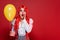 amazed redhead woman in clown makeup