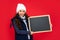 amazed teen girl holding chalkboard with copy space. child back to school. announcement