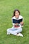 amazed teen girl read book sitting on grass. reading book. reader girl with book outdoor