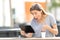 Amazed teenage girl using a tablet sitting in a park