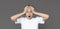 Amazed teenager screaming, holding head, grey background