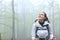 Amazed trekker walking looking above in a forest