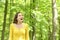 Amazed woman walking in a forest contemplating