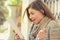 Amazed woman watching tablet on street