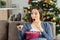 Amazed woman watching tv in christmas holidays